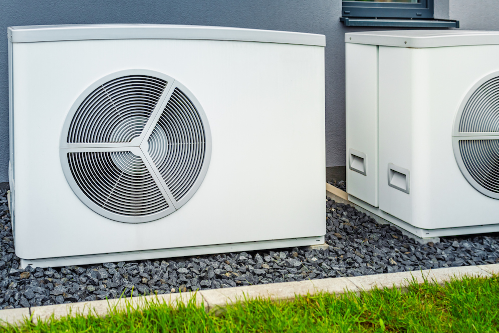 wo air source heat pumps installed outside of new and modern city house wo air source heat pumps installed outside of new and modern city house
