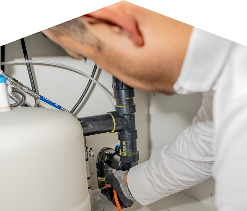 A Romaniuk plumbing specialist uses a hydro jet to clear a clogged drain.