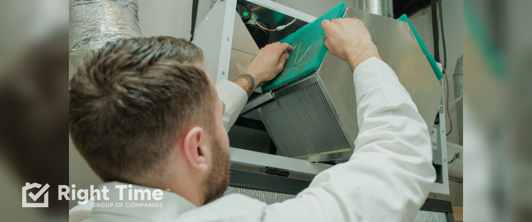 Technician changing a furnace air filter to improve winter comfort in Red Deer.