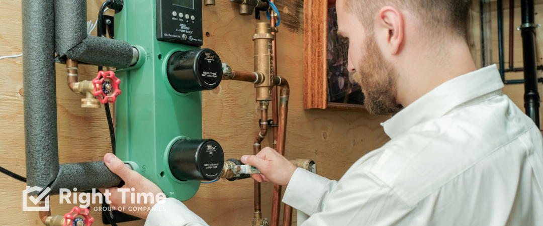 Technician inspecting a boiler circulation pump and controls in an Edmonton home.